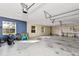 Spacious three-car garage with ample storage space and natural light, perfect for parking and hobbies at 27320 Egret Pl, Punta Gorda, FL 33983