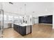 Large kitchen featuring an island with bar seating, stainless steel appliances, and wood floors at 27320 Egret Pl, Punta Gorda, FL 33983