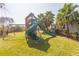 Backyard playground featuring a wooden playset with a slide and swings, perfect for Gathering fun at 27320 Egret Pl, Punta Gorda, FL 33983