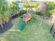 Aerial view of wood playground set featuring slides, swings, and climbing structure at 27320 Egret Pl, Punta Gorda, FL 33983