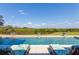 Beautiful pool view with two lounge chairs ready to be enjoyed on a sunny day at 27320 Egret Pl, Punta Gorda, FL 33983