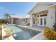 Beautiful pool area with in-ground pool, elegant water features, and outdoor lounge area at 27320 Egret Pl, Punta Gorda, FL 33983