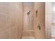 Modern walk-in shower featuring updated fixtures, bench and tiled surround at 27320 Egret Pl, Punta Gorda, FL 33983