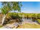 Private wooden dock on a tranquil waterway, surrounded by lush greenery and natural beauty at 27320 Egret Pl, Punta Gorda, FL 33983