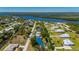 Aerial view of a charming home featuring a pool, lush landscaping, and picturesque waterfront surroundings at 28482 Coco Palm Dr, Punta Gorda, FL 33982