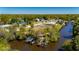 Waterfront lot featuring dock and canal access with a verdant landscape and nearby homes at 28482 Coco Palm Dr, Punta Gorda, FL 33982