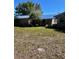 View of the backyard and exterior of the home with a manicured lawn, showing the spacious outdoor area at 28482 Coco Palm Dr, Punta Gorda, FL 33982