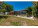 Screened-in pool enclosure in backyard with lush landscaping, offering a private oasis at 28482 Coco Palm Dr, Punta Gorda, FL 33982