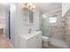 Bathroom featuring marble-style shower and modern vanity with storage at 28482 Coco Palm Dr, Punta Gorda, FL 33982