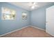 Sunlit bedroom with neutral walls, tile flooring, ceiling fan, and two windows at 28482 Coco Palm Dr, Punta Gorda, FL 33982