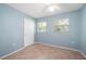 Bright bedroom features tile flooring, a ceiling fan, and two windows providing natural light at 28482 Coco Palm Dr, Punta Gorda, FL 33982