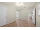Well-lit bedroom with ceiling fan, tile flooring, and multiple entryways at 28482 Coco Palm Dr, Punta Gorda, FL 33982