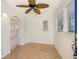 Bright entryway features parquet floors, a decorative ceiling fan, and an arched doorway leading to other living areas at 28482 Coco Palm Dr, Punta Gorda, FL 33982