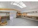A large garage with lots of open storage and skylight to help brighten up the space at 28482 Coco Palm Dr, Punta Gorda, FL 33982