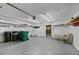 Well-lit garage with ample storage space, shelving, and an exit door to the exterior at 28482 Coco Palm Dr, Punta Gorda, FL 33982