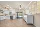 Bright kitchen features stainless steel appliances, custom cabinetry, tile floors, recessed lighting, and access to the lanai at 28482 Coco Palm Dr, Punta Gorda, FL 33982