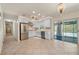 Bright kitchen features stainless steel appliances, custom cabinetry, tiled floors, recessed lighting, and lanai access at 28482 Coco Palm Dr, Punta Gorda, FL 33982