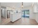 Bright, renovated eat-in kitchen with stainless steel appliances, center island, tile floors, and access to lanai at 28482 Coco Palm Dr, Punta Gorda, FL 33982