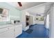 Bright kitchen featuring stainless steel appliances, white cabinetry, and a unique blue floor at 28482 Coco Palm Dr, Punta Gorda, FL 33982