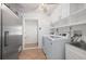 Functional laundry room with modern washer, dryer, ample storage, and convenient utility sink at 28482 Coco Palm Dr, Punta Gorda, FL 33982