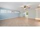 Bright living room with tile floors, ceiling fan, and sliding glass doors to another room at 28482 Coco Palm Dr, Punta Gorda, FL 33982