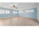 Bright living room features tile flooring, plantation shutters, and a ceiling fan at 28482 Coco Palm Dr, Punta Gorda, FL 33982