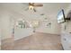 Open living room featuring tile floors, recessed lighting, and an archway leading to a modern kitchen with stainless steel appliances at 28482 Coco Palm Dr, Punta Gorda, FL 33982
