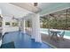 Bright sunroom with tile flooring, access to pool area, ceiling fan, and lots of natural light at 28482 Coco Palm Dr, Punta Gorda, FL 33982