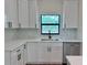Bright kitchen features shaker cabinets, quartz countertops, and a stainless steel dishwasher at 2920 Barry Rd, North Port, FL 34286