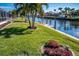 Sprawling backyard with lush landscaping and a private canal with dock at 529 Belvedere Ct, Punta Gorda, FL 33950