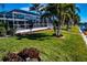 Lush backyard with screened lanai, leading to the canal and private dock at 529 Belvedere Ct, Punta Gorda, FL 33950
