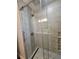 Bathroom shower featuring neutral tile, a glass door, and modern fixtures at 529 Belvedere Ct, Punta Gorda, FL 33950