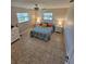 Bright bedroom featuring patterned bedding, matching nightstands, and ample natural light from dual windows at 529 Belvedere Ct, Punta Gorda, FL 33950