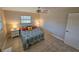 Inviting bedroom with patterned bedding, white nightstands, and soft, natural light streaming through the windows at 529 Belvedere Ct, Punta Gorda, FL 33950