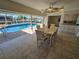 Bright dining area with a waterfront view, featuring a dining table, modern lighting, and access to a pool at 529 Belvedere Ct, Punta Gorda, FL 33950