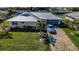 Well-maintained single-Gathering home with a metal roof, a brick-paved driveway, and lush, green lawn at 529 Belvedere Ct, Punta Gorda, FL 33950