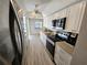 Bright kitchen featuring stainless steel appliances, shaker cabinets, and a modern countertop with an adjacent pool view at 529 Belvedere Ct, Punta Gorda, FL 33950