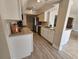 Bright kitchen featuring stainless steel appliances, shaker cabinets, a modern countertop, and wood look floors at 529 Belvedere Ct, Punta Gorda, FL 33950