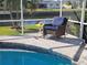 Cozy wicker chair next to an outdoor screened in pool at 529 Belvedere Ct, Punta Gorda, FL 33950