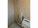 Accessible tiled shower featuring grab bars and a folding seat at 529 Belvedere Ct, Punta Gorda, FL 33950