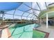 Screened-in pool area featuring a clear pool, tile accents, and comfortable seating area at 606 Santa Margerita Ln, Punta Gorda, FL 33950