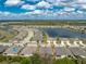 Wide aerial shot of the home next to a serene lake and landscaped surroundings at 7393 West Lenox Cir, Punta Gorda, FL 33950