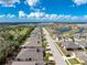 Aerial view of a residential area featuring a home near a tranquil lake at 7393 West Lenox Cir, Punta Gorda, FL 33950