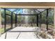Spacious screened-in lanai with clear view of the landscaped backyard at 7393 West Lenox Cir, Punta Gorda, FL 33950