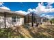 Landscaped backyard featuring a screened lanai, complemented by lush greenery at 7393 West Lenox Cir, Punta Gorda, FL 33950