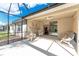 Exterior view of the screened lanai and slider door to backyard at 7393 West Lenox Cir, Punta Gorda, FL 33950