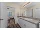 Bright bathroom features double sink vanity, an adjacent bedroom, and a neutral color palette at 7393 West Lenox Cir, Punta Gorda, FL 33950