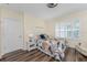 Cozy bedroom with plank flooring, plantation shutters, and a comfortable bed dressed with a floral comforter at 7393 West Lenox Cir, Punta Gorda, FL 33950