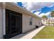 Side exterior view with a screened entry and walkway to the front yard at 7393 West Lenox Cir, Punta Gorda, FL 33950