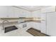 Bright kitchen featuring white cabinetry, stainless steel sink, and modern appliances at 7393 West Lenox Cir, Punta Gorda, FL 33950